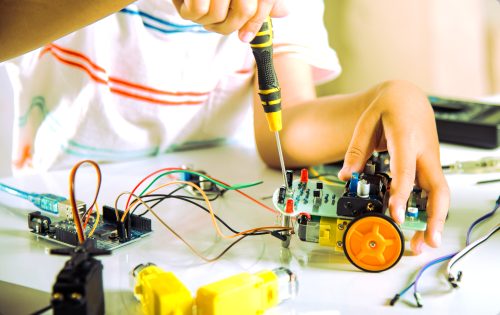 Asian,Kid,Boy,Assembling,The,Arduino,Robot,Car,Homework,Project